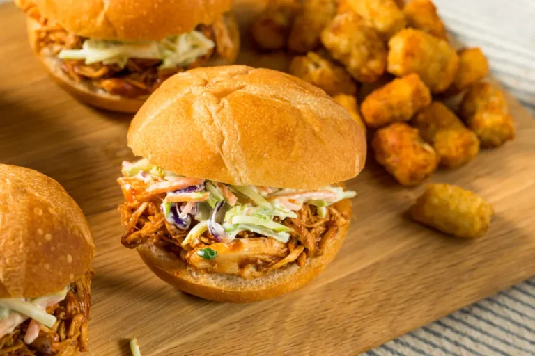 Buffalo chicken sliders with melted cheese and a golden toasted bun.