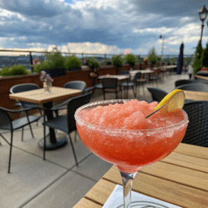 Slushy paper plane cocktail with lemon garnish